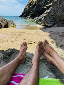 Relaxing by the sea on a small unspoilt beach surrounded by rocks in Menorca. Relaxing by the sea on a small unspoilt beach surrounded by rocks in Menorca.