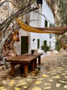 Whitewashed country house with a hammock beneath the trees in an idyllic corner of Menorca. Whitewashed country house with a hammock beneath the trees in an idyllic corner of Menorca.